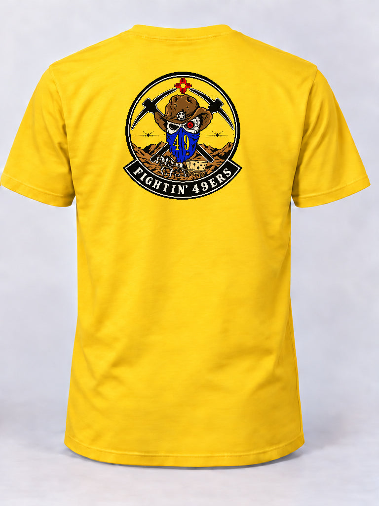Yellow 49 OG morale shirt featuring the Fightin’ 49ers cowboy skull emblem, crossed picks, aircraft, and horse-drawn wagon.