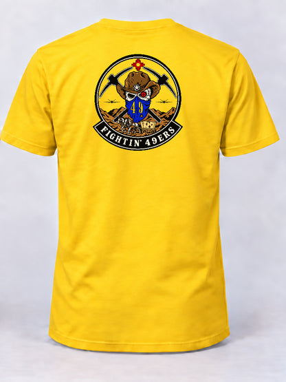 Yellow 49 OG morale shirt featuring the Fightin’ 49ers cowboy skull emblem, crossed picks, aircraft, and horse-drawn wagon.