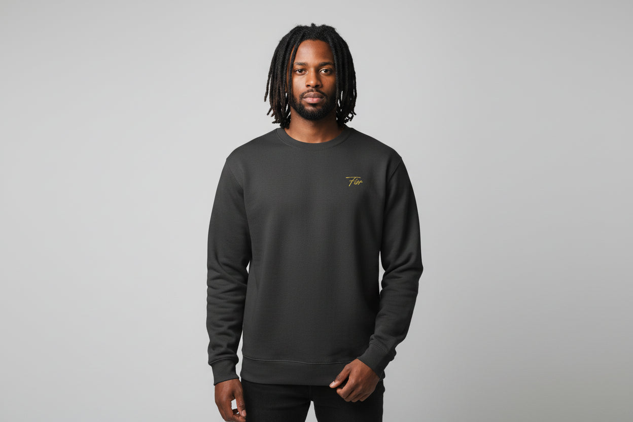 Dark gray sweatshirt with a small yellow logo on the chest against a black background