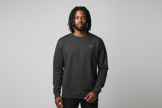 Dark gray sweatshirt with a small yellow logo on the chest against a black background